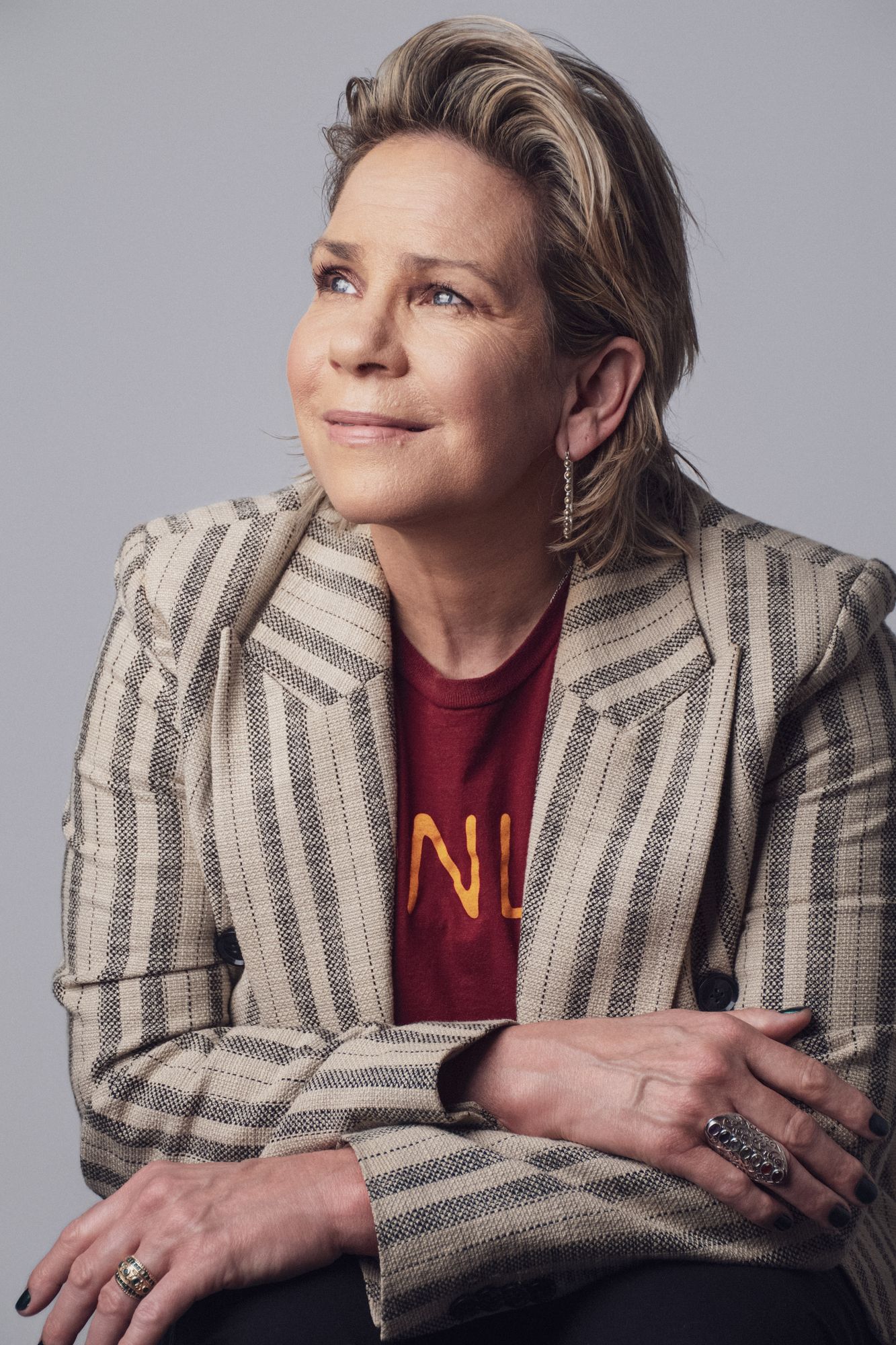 A studio portrait of a woman in a striped blazer