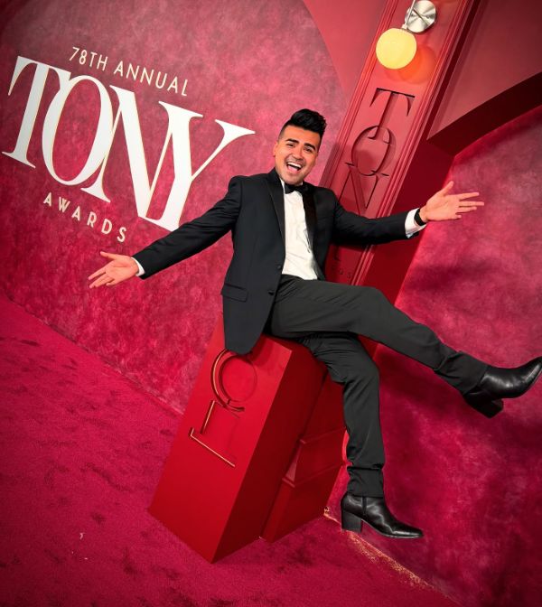 A guest laughs on the red carpet set at the Tony Awards